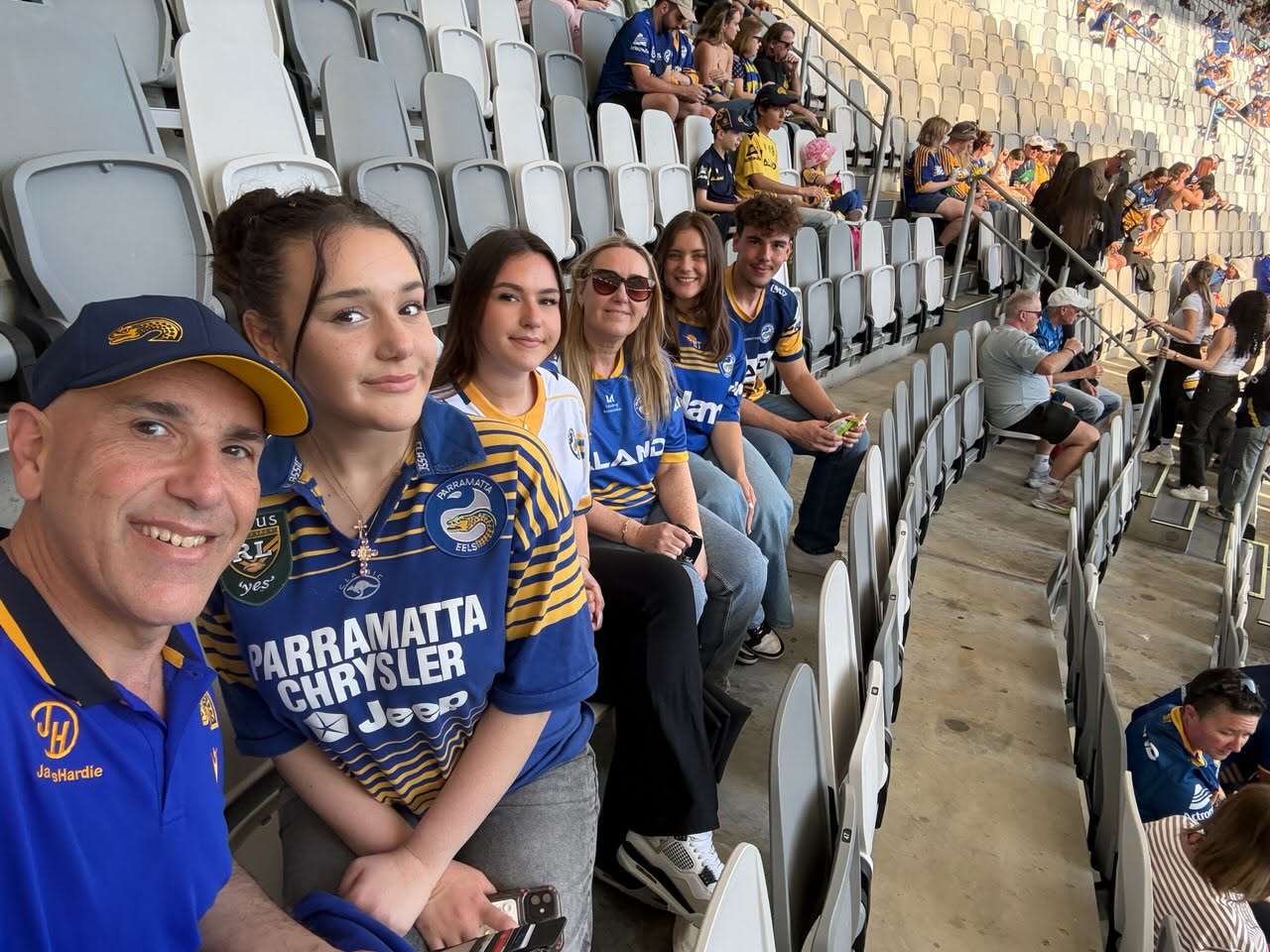 Chris and his family attending a Parramatta Eels game.